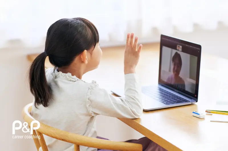 Young child under 6 waving to parent video a laptop to show distance between them