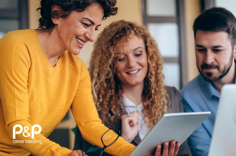 Three professionals in a meeting one is holding a ipad